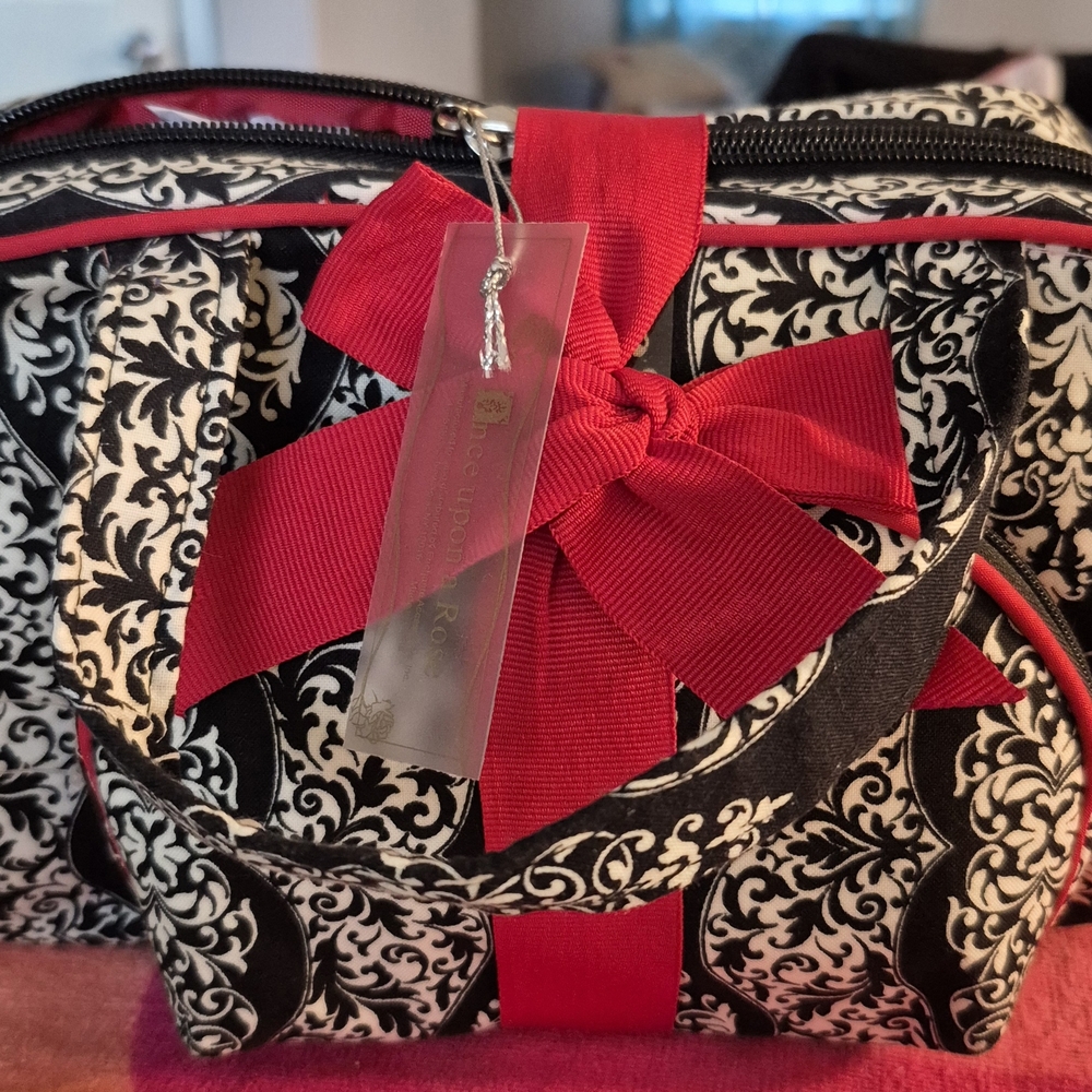 Elegant Black and White Patterned Bag with Red Accents